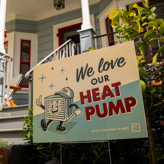 Promotional sign for a heat pump in front of a house