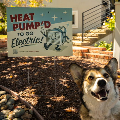 Dog in front of a 'Heat Pump'd to Go Electric!' sign in a garden setting