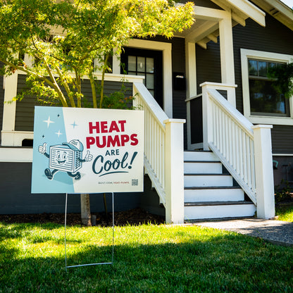 Promotional sign for heat pumps in front of a house